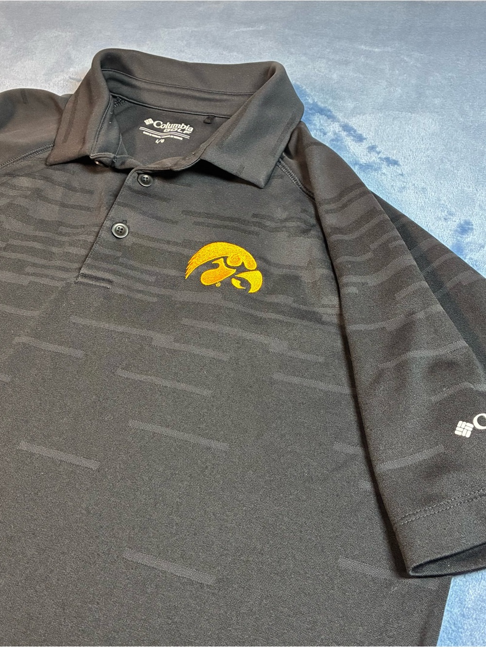 Columbia Men’s Black Polo with Gold Iowa Hawkeyes Logo